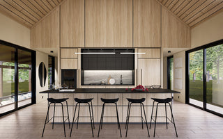Modern open kitchen interior design for a mountain cabin, featuring a light beige wood island with open shelving for pantry items, a large fridge, oven, and black wood bar stools.