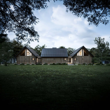 Modern house with wooden exterior and glass windows surrounded by trees under a clear sky.