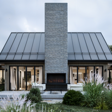 A modern A-frame cabin with a sloped black metal roof and wooden exterior set against a natural background of trees and grass. The structure includes large glass windows, a prominent chimney with smoke rising, and an adjacent garage. The scene is illuminated by soft daylight, emphasizing the clean lines and natural materials of the design