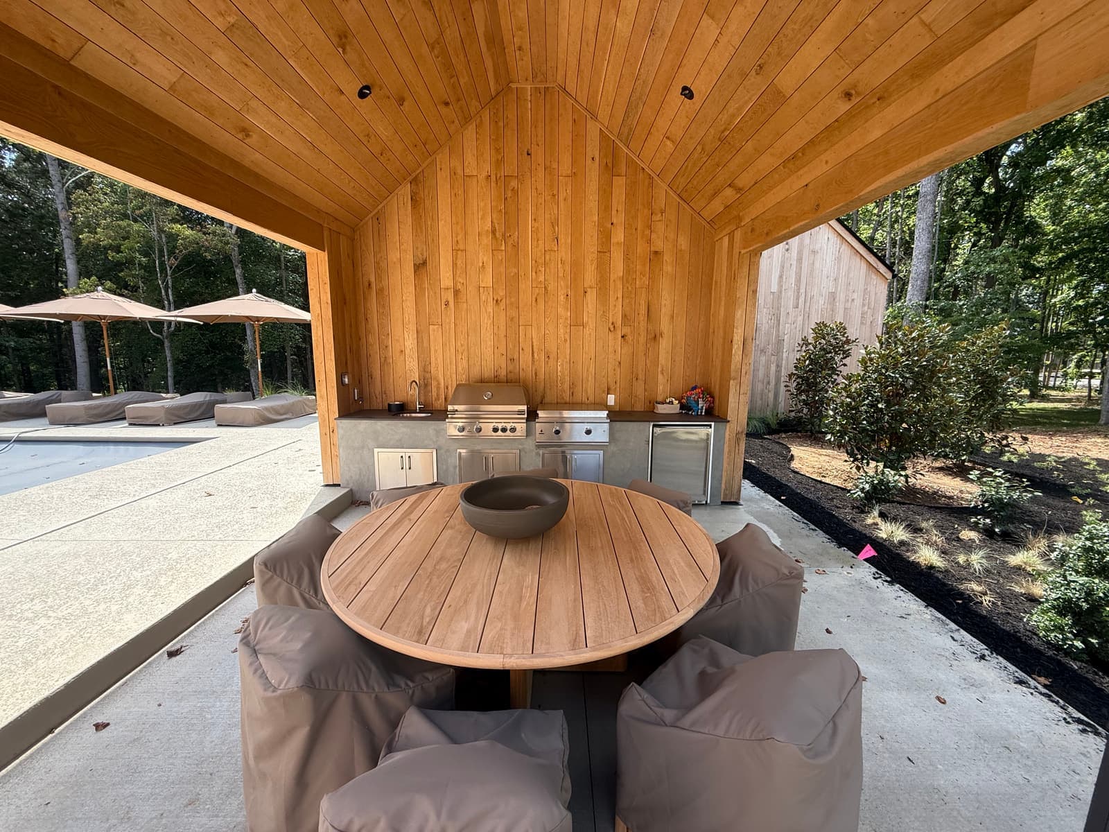A wood-lined dining room with a round table.