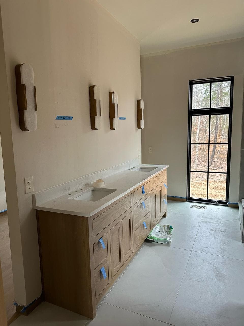 A vanity in progress under a window.