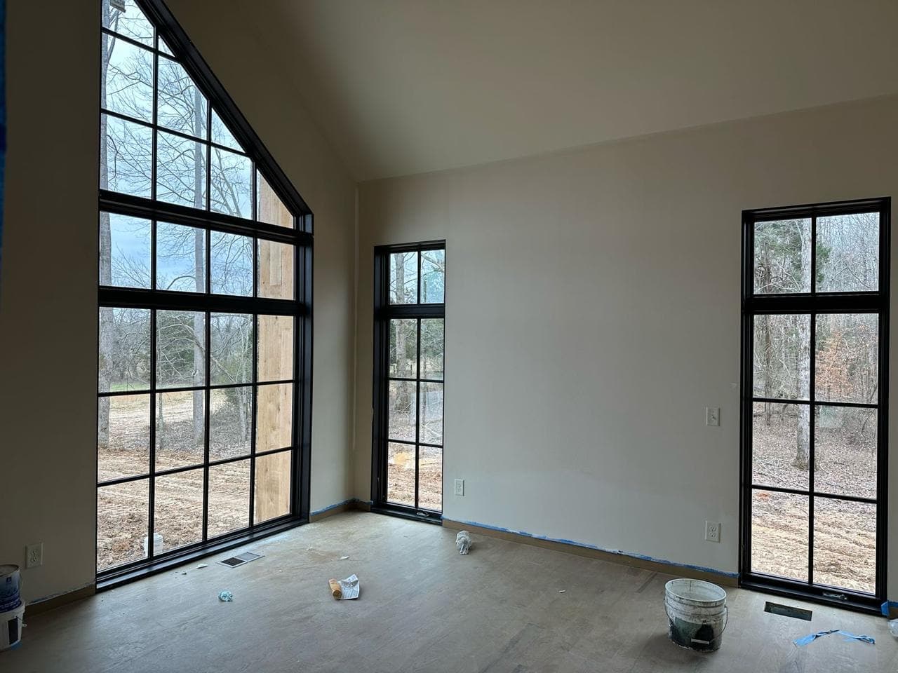 A green-painted room with a black window.