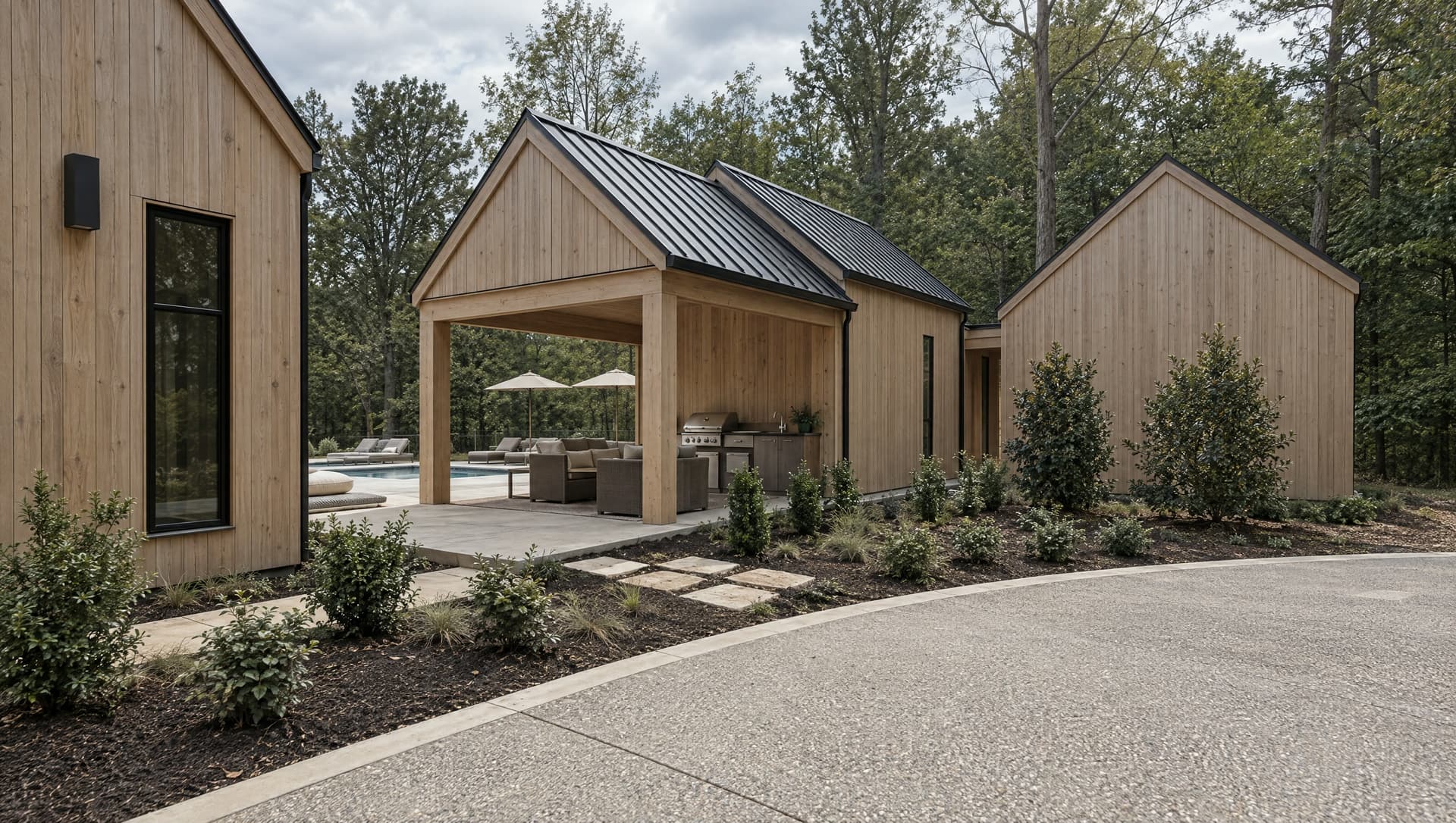 Pale wood gables around a covered outdoor room, with a pool beyond.