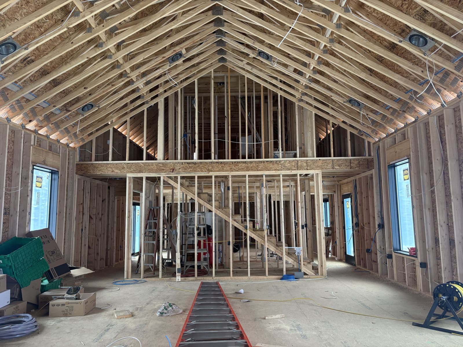 The full roof structure over the great room, loft wall framed below it.
