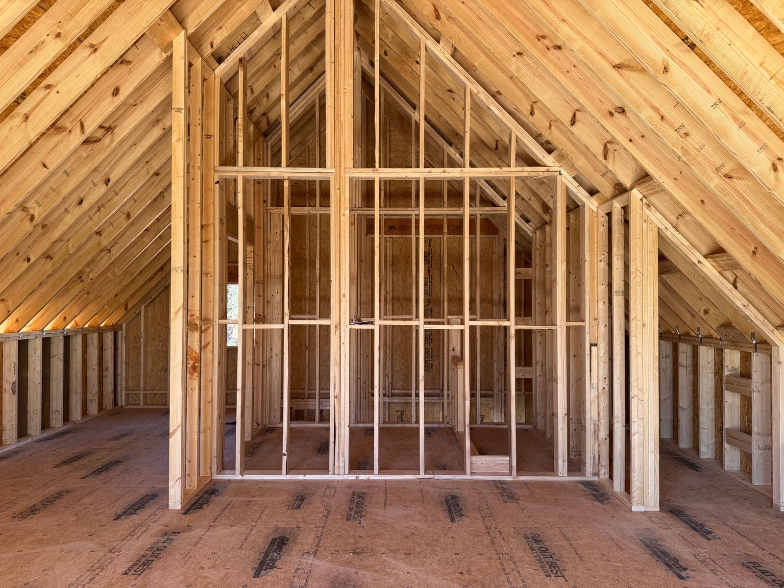 Inside the gable: rafters, a stud wall for the upper opening, subfloor.