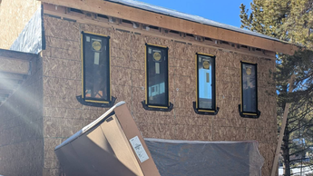 Janesse's Residence, a building site in Leadville, CO, a garage exterior with windows and a clear blue sky.