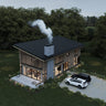 Aerial view of a modern cabin nestled in the forest, featuring a sloped black metal roof, central stone chimney with smoke, and wood-clad exterior with large vertical windows. A gravel driveway with two parked cars and a cozy patio with a firepit enhance the natural setting.