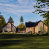 Modern cabin house with stone and wood exterior in a green landscape
