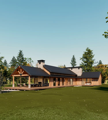 A modern rustic home with a black metal roof, exposed wooden beams, and large glass windows, surrounded by lush greenery. The house features an expansive covered outdoor patio with a dining area, seamlessly blending indoor and outdoor living.
