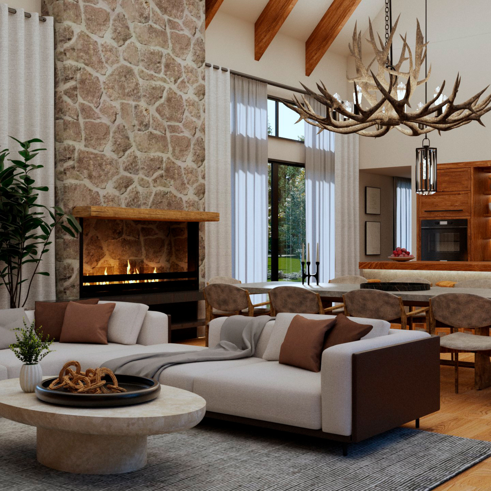 Warm and inviting open-concept living space featuring a stone fireplace, vaulted wood beam ceiling, and a stunning antler chandelier. The cozy seating area with neutral-toned sofas and a round stone coffee table seamlessly blends with the rustic dining area and modern kitchen, creating the perfect balance of comfort and elegance.