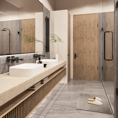 Modern minimalist bathroom with double vessel sinks on a light stone countertop, wood slat vanity with open shelving, large backlit mirror, walk-in shower with glass door, natural wood accents, gray floor tiles, and cozy slippers on a gray rug.