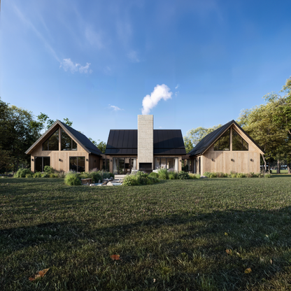 A modern cabin with a rustic design, featuring a central stone chimney, large triangular windows, and a black metal roof. The structure is surrounded by lush greenery and a spacious lawn, blending seamlessly with the natural landscape under a bright blue sky