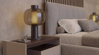 Modern master bedroom of The Writer's Retreat with a nightstand and a Bonbori Brokis table lamp next to a Restoration Hardware king-size bed.