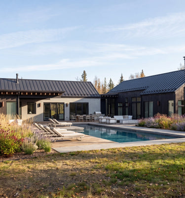 Modern house with a pool surrounded by trees and greenery in New York. Modern Mountain Home, THE HUT COMPANY