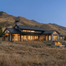 The Hunter's Lodge, a modern custom luxury house with a mountainous landscape at sunset. A three level residence in Pensylvannia with an open concept layout and expansive windows. 