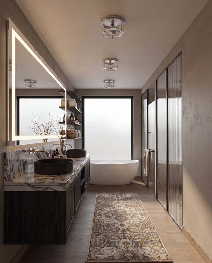 The Maine Project: A modern bathroom interior with a double vanity, marble countertop, black vessel sinks, a freestanding bathtub, walk-in closet doors, and a patterned runner rug on a light wood floor.