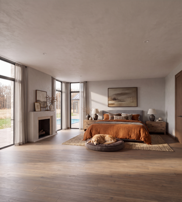 Coyotes Den: A modern, spacious bedroom with light wood floors, a textured plaster ceiling, a bed dressed in orange bedding, a fireplace on the left, and a dog resting on a round pet bed in the foreground.